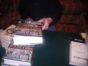Kevin finishes signing the store's stock of his books